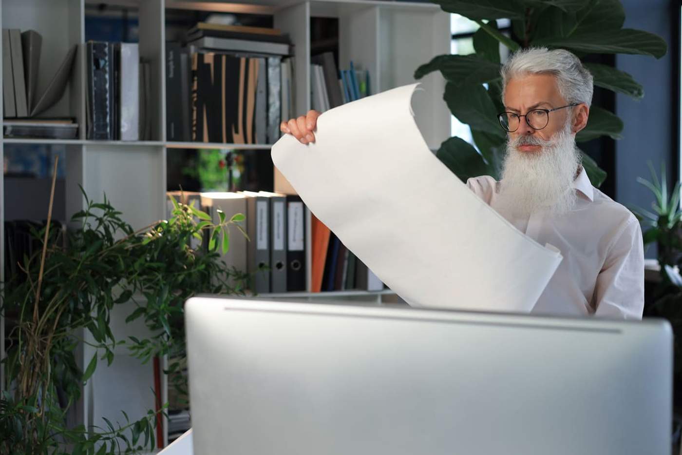 Office worker reviewing a large printout after buying the best budget printer for small business operations