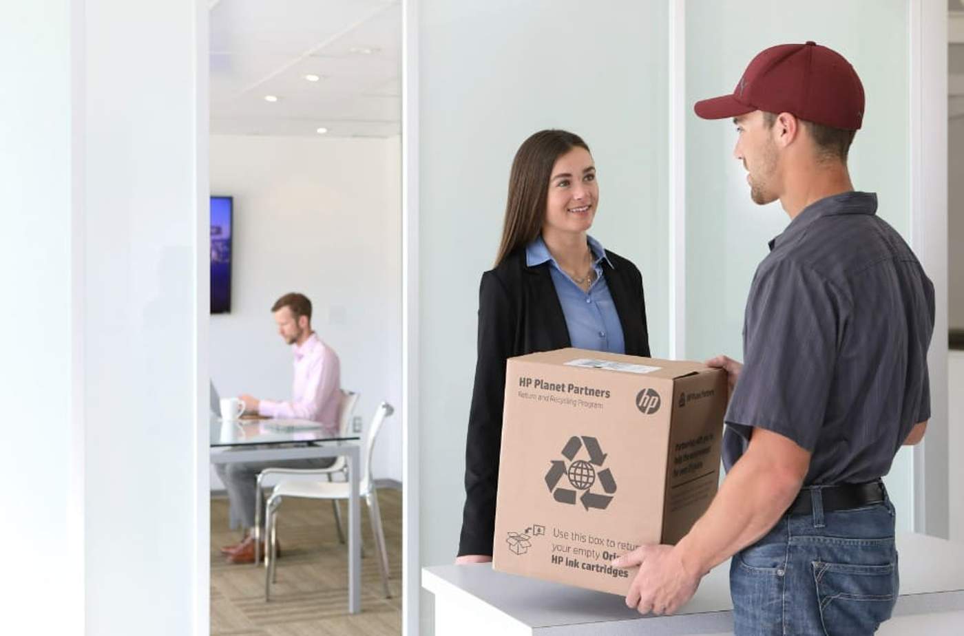 HP employee providing plotter recycling solutions to an office