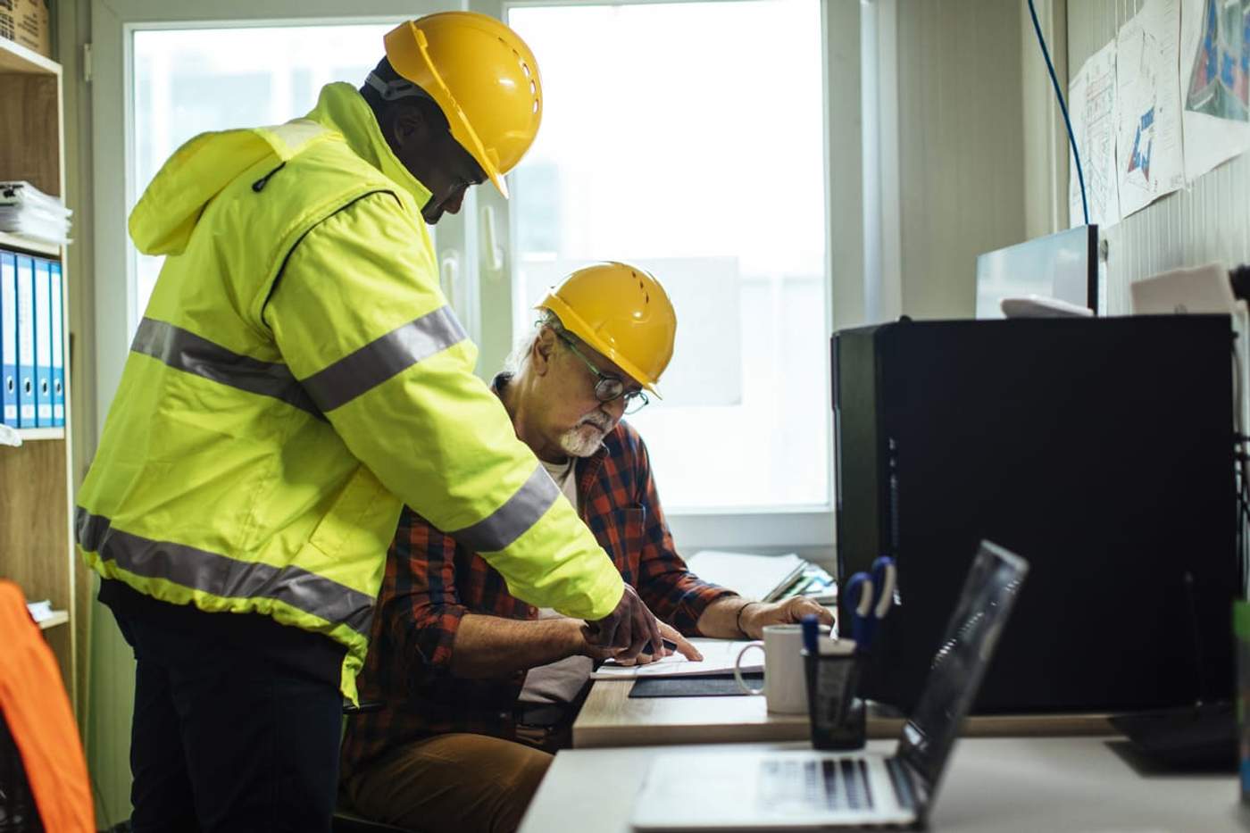 Construction site managers creating a plan for cybersecurity in construction outposts