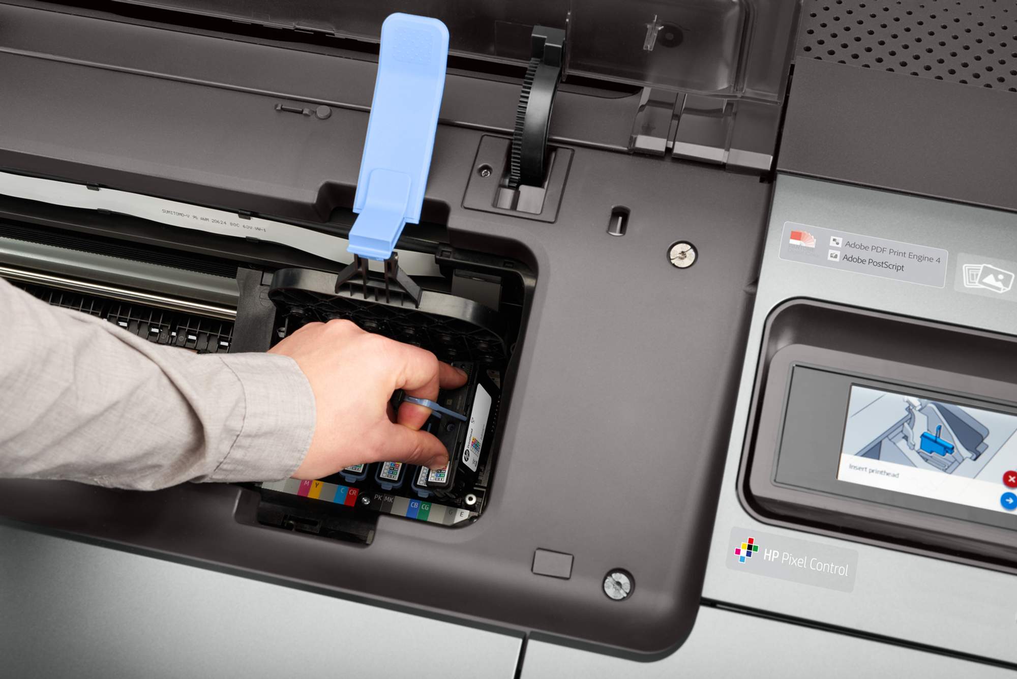Technician inspecting printer ink as part of a large format printer maintenance checklist